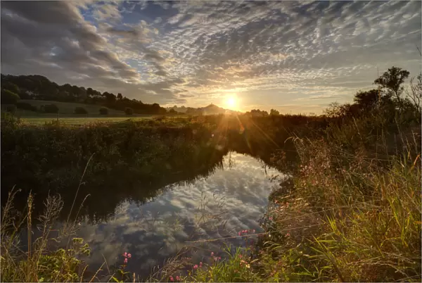River Brue, at sunrise with Glastonbury Tor in background, Somerset, UK, August