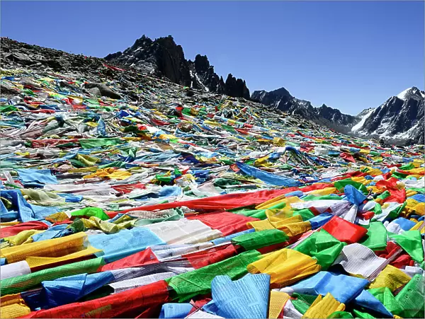 Hundreds of prayer flags at Dolma La Pass, highest point on pilgrimage around sacred Mount Kailash. Tibet, China
