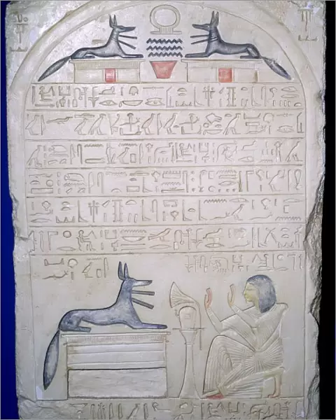 Egyptian elief stele of a man adoring Anubis