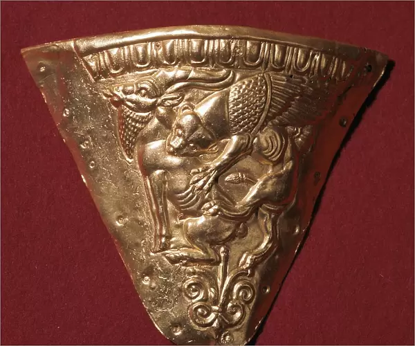 Scythian gold plate showing a winged panther attacking a goat