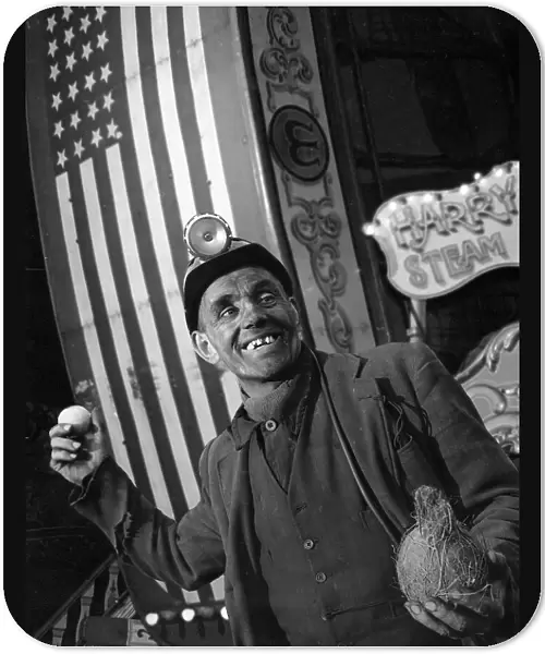 Miner at a fairground, Conisbrough, near Doncaster, South Yorkshire, 1955. Artist