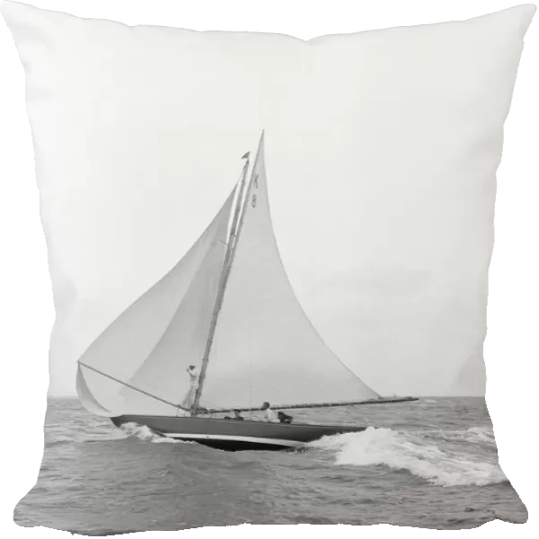 The 7 Metre yacht Pinaster (K8) sailing with spinnaker, 1913. Creator: Kirk & Sons of Cowes