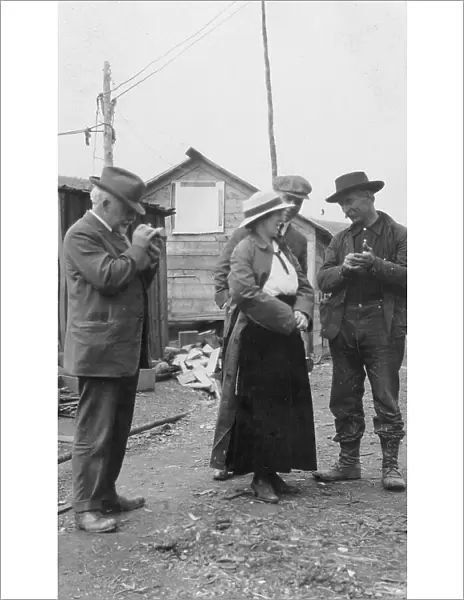 Woman and three men talking outside, between c1900 and 1916. Creator: Unknown