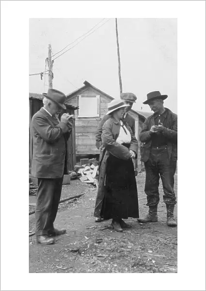 Woman and three men talking outside, between c1900 and 1916. Creator: Unknown