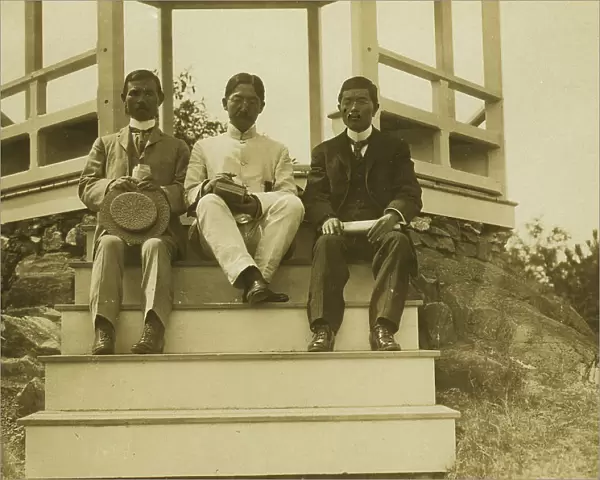 Three Japanese men, possibly journalists, seated on the steps of a gazebo, 1905. Creator: Unknown