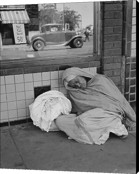 She awaits the international streetcar at a corner in El Paso, Texas to return across... 1938. Creator: Dorothea Lange