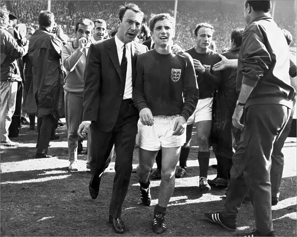 Jimmy Greaves puts an arm round the exhausted Alan Ball
