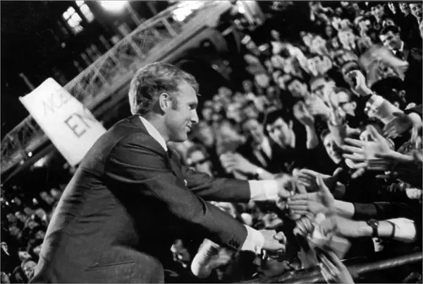 England captain, Bobby Moore, shakes hands with jubilant supporters at the World Cup celebrations