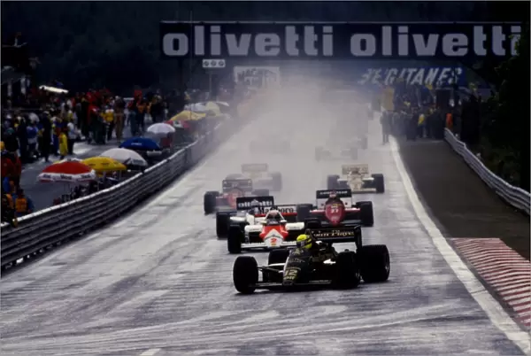 Formula One World Championship: Race winner Ayrton Senna Lotus 97T leads the field into La Source at the start of the race