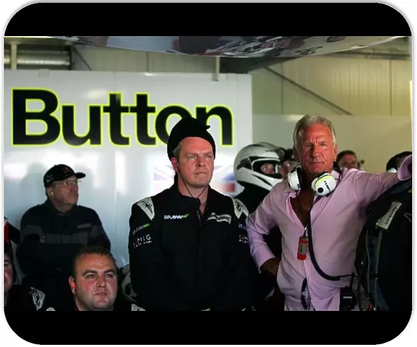 Formula One World Championship: John Button watches the race in the Brawn Grand Prix pit as his son Jenson leads the race