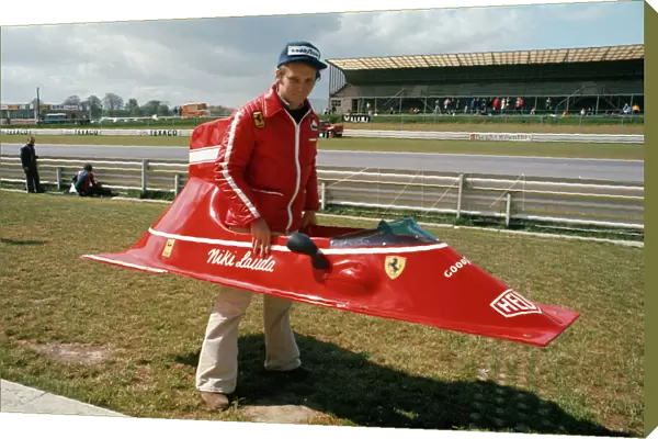 1974 Belgian Grand Prix - Niki Lauda: Niki Lauda playing with bodywork from his Ferrari 312B3. Portrait