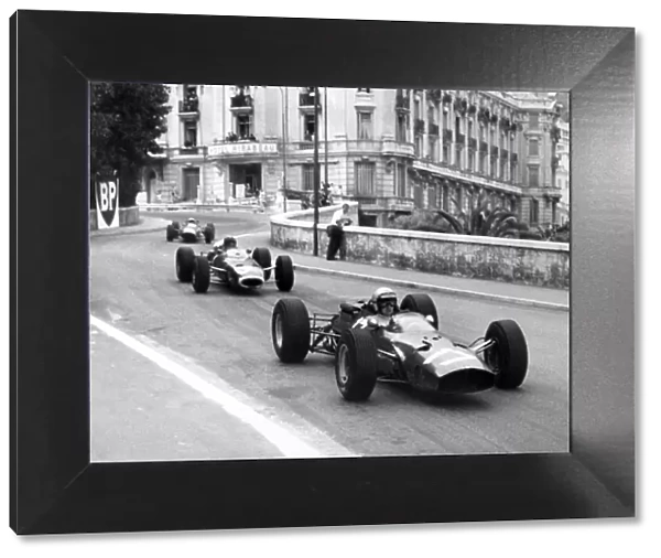 Monte Carlo, Monaco. 28-30 May 1965: Lorenzo Bandini, Ferrari 1512, 2nd position, leads Graham Hill, BRM P261, 1st position, action