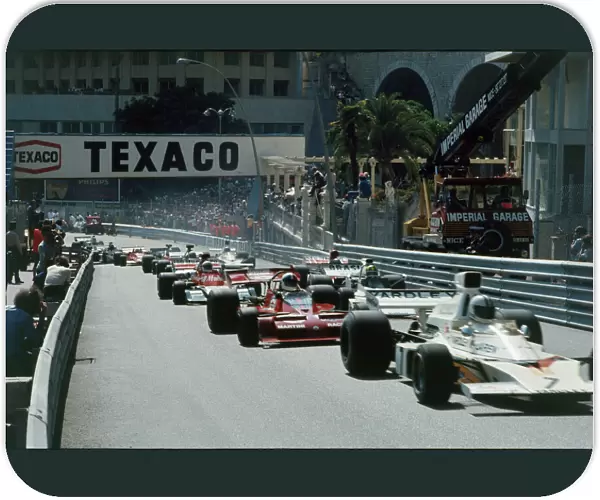1973 Monaco Grand Prix: Denny Hulme 6th position, leads Chris Amon, retired, and Wilson Fittipaldi, 11th position, at the start, action