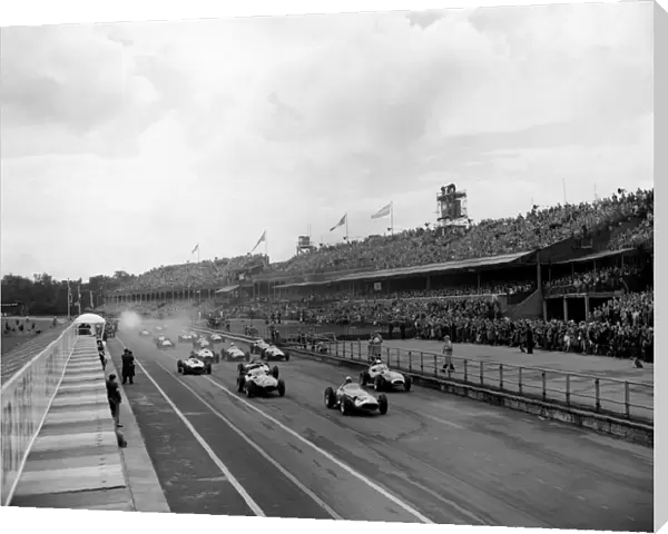 1957 British Grand Prix: Jean Behra, retired, leads at the start, with Stirling Moss, 1st position and Tony Brooks, retired, close behind, action