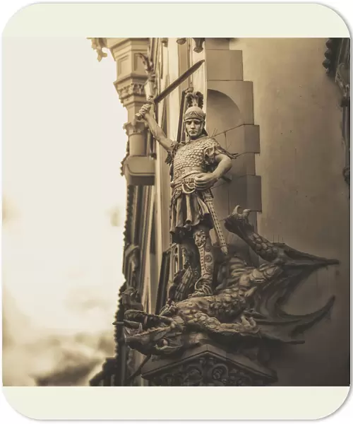 Statue On The Side Of A Building Of A Warrior Slaying A Dragon; Prague, Czech Republic