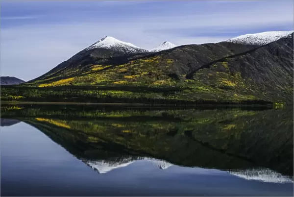 Reflection Of The Mountains Surrounding Carcross Reflected In The Still Waters; Yukon, Canada