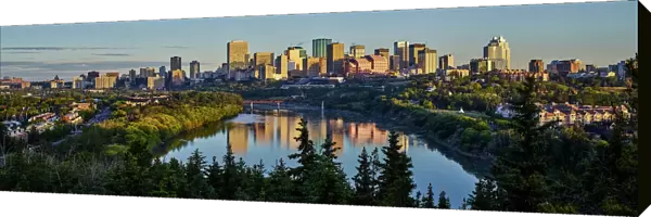 Skyline Of Downtown Edmonton Reflected In The North Saskatchewan River Under A Blue Sky; Edmonton, Alberta, Canada