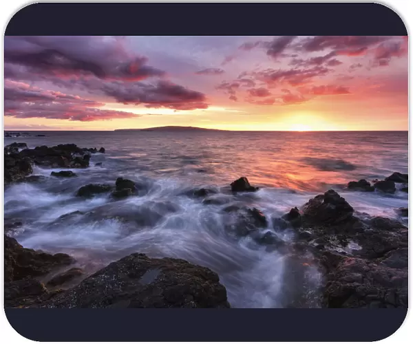 Soft water over lava rocks with a red sunset, Maui, Hawaii, USA