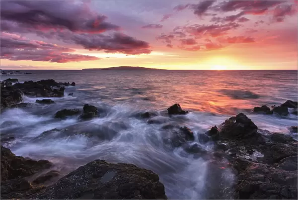 Soft water over lava rocks with a red sunset, Maui, Hawaii, USA