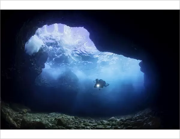 Diver and cavern, Hawaii, USA