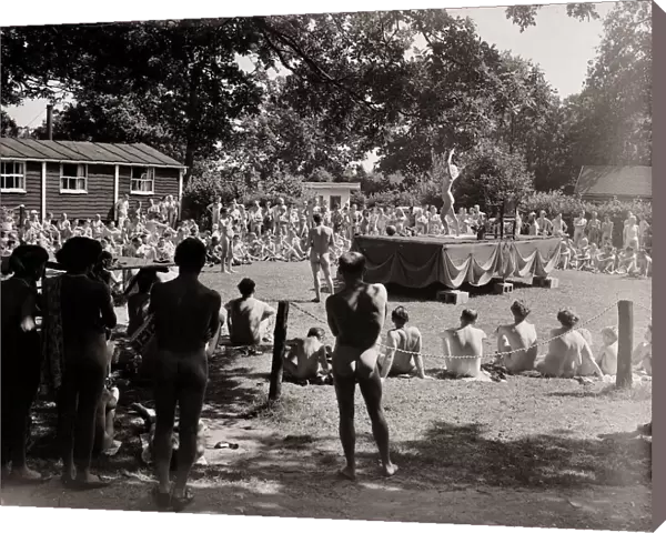 Nudist Beauty Contest - August 1957 people gather round a stage to view contestants