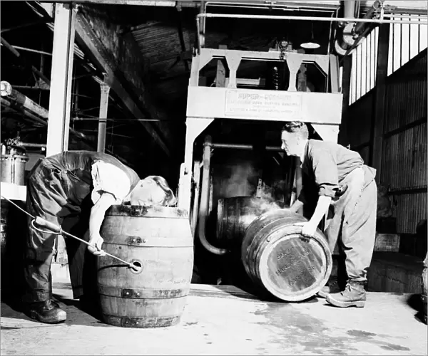 A barrel inspector at work at Hancocks Brewery in Cardiff. July 1952 C3603-003