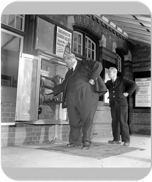 Fat Man John Feathestone seen here buying a ticket at his local railway station