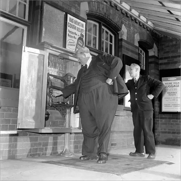 Fat Man John Feathestone seen here buying a ticket at his local railway station