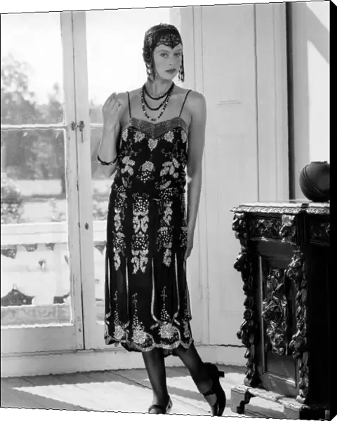 1920s fashions: Beaded flapper dress and skull cap with neat T-bar shoes