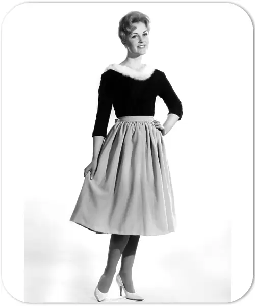 Reveille Fashions 1961: Roma Reeves modelling a fur trimmed sweater and skirt