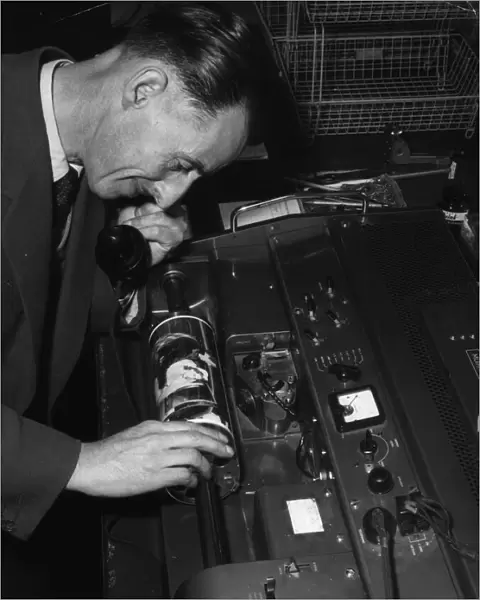 Technician overseeing the transmission of an image in the Telephoto room at the Daily