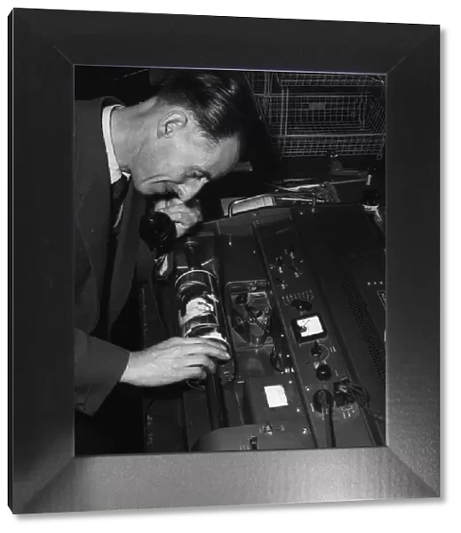 Technician overseeing the transmission of an image in the Telephoto room at the Daily