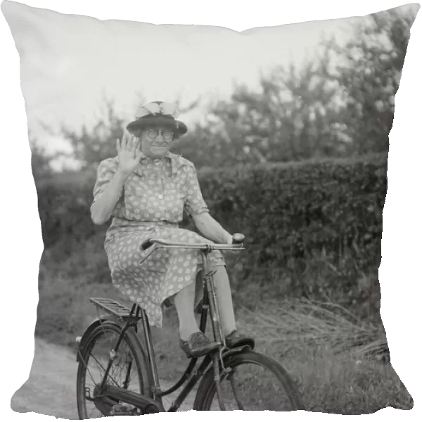 Mrs Hilda Baker seen here coasting downhill on her bicycle with her feet up on the front