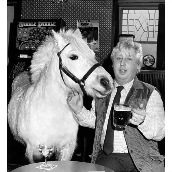 Horse trainer Trevor Simmons with Dimples the horse at the local pub. March 1985