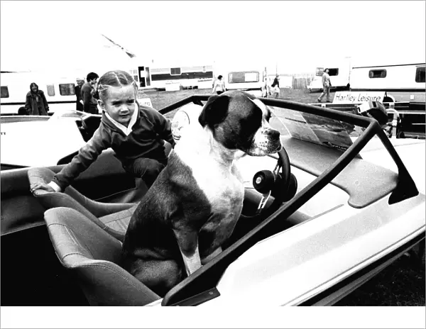 A young girl and her dog try out a speedboat at the Whitley Bay Motor Show. 18  /  07  /  80