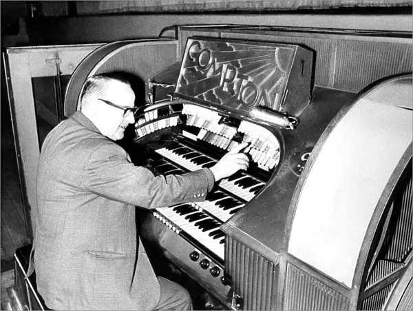 Mr. Wilf Donnelly of the Theatre Organ Club seated at the organ of the Odeon