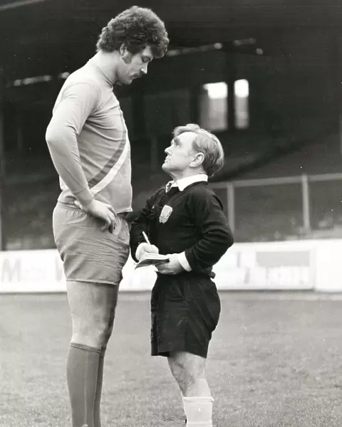 Pocket-sized referee telling off a tall footballer at Reading in Berkshire. February 1980