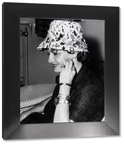 American actress Jane Russell wearing flowerpot hat holding her hand to her face