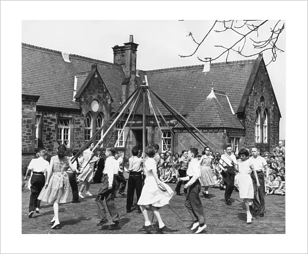 Children having fun around the maypole