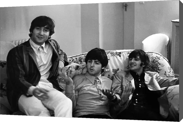 John Lennon, Paul McCartney and Ringo Starr of The Beatles relax in their room at