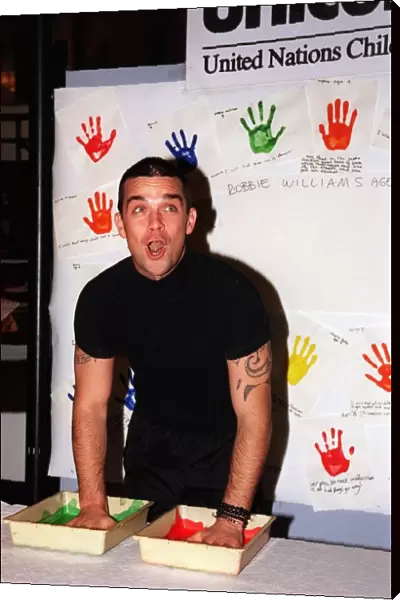 Robbie Williams gets his hands dirty November 1999 for childrens rights