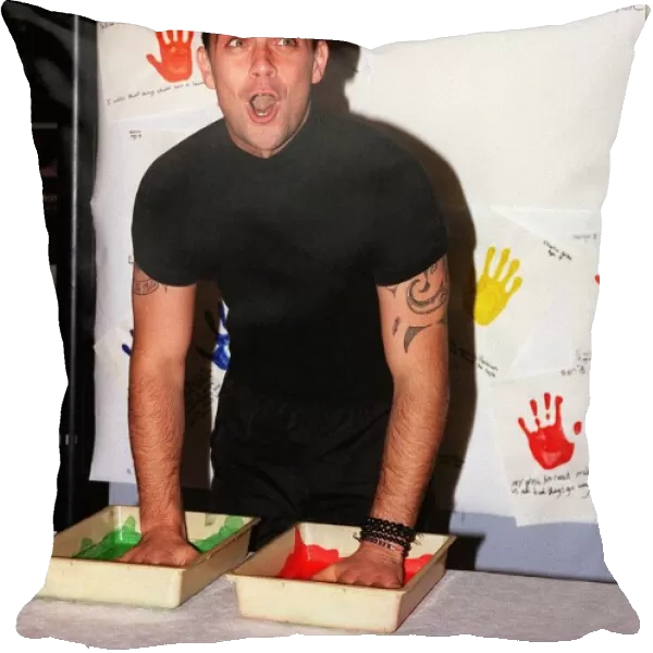Robbie Williams gets his hands dirty November 1999 for childrens rights