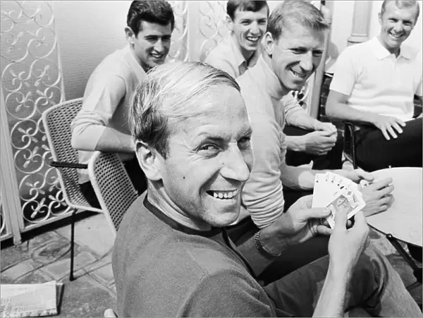 Bobby Charlton holds a full house in a game of cards with team mates, l-r Peter Bonetti