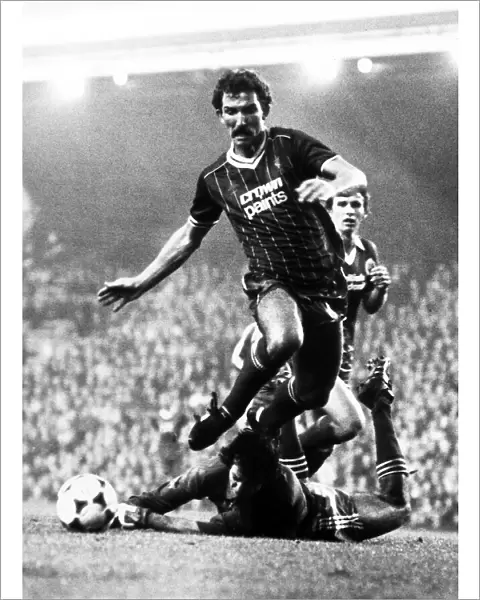 Graeme Souness of Liverpool jumps over Brighton goalkeeper Graham Mosely during the two