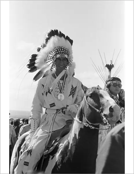 Prince Charles, the Prince of Wales, wearing Indian headdress in Calgary