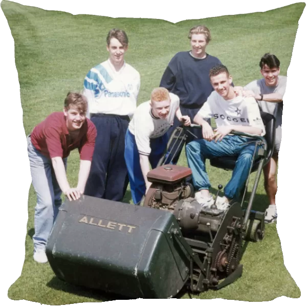Manchester United youth team players surrounding a lawnmower on the pitch at The Cliff
