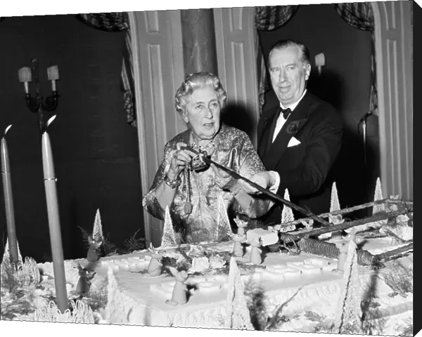 Agatha Christie cuts cake with sword 1962 at 10th anniversary of the play Mousetrap
