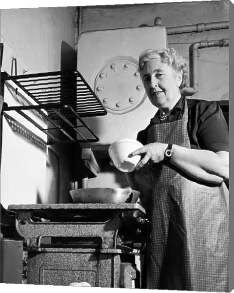 British author Agatha Christie pictured cooking in the kitchen at her home at Winterbrook