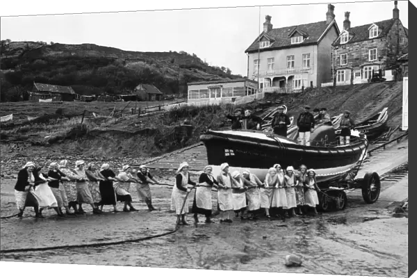 Women of Runswick Bay in Yorkshire, all pulling together on the rope to launch