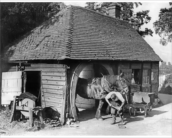 The village blacksmith pursuing his ancient craft in the picturesque village of Claverdon